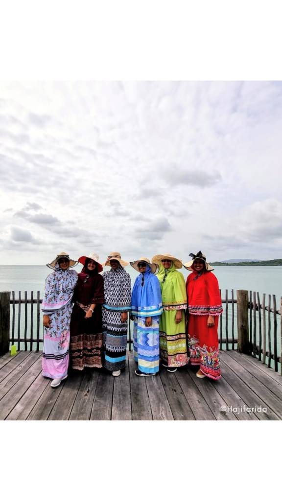 muslim women in colorful ridas at the beach resort, mothers on a holiday, 6 muslim women at the beach